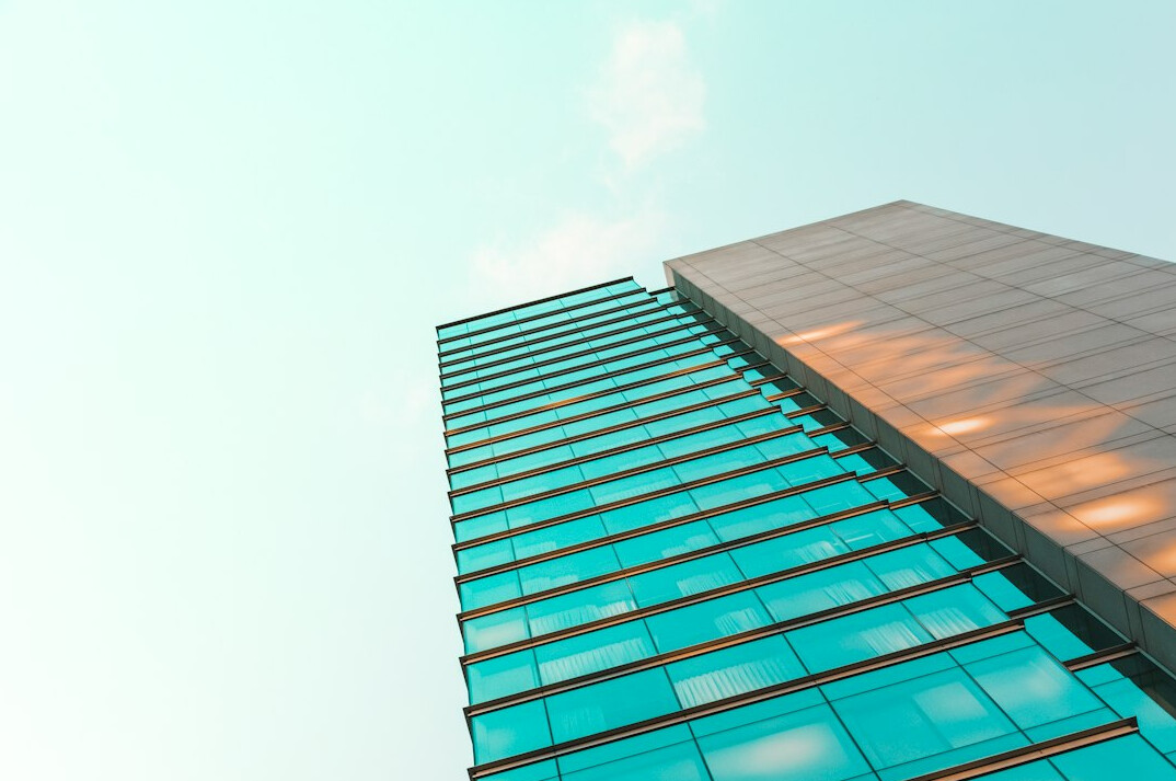 Modern glass office building seen from below